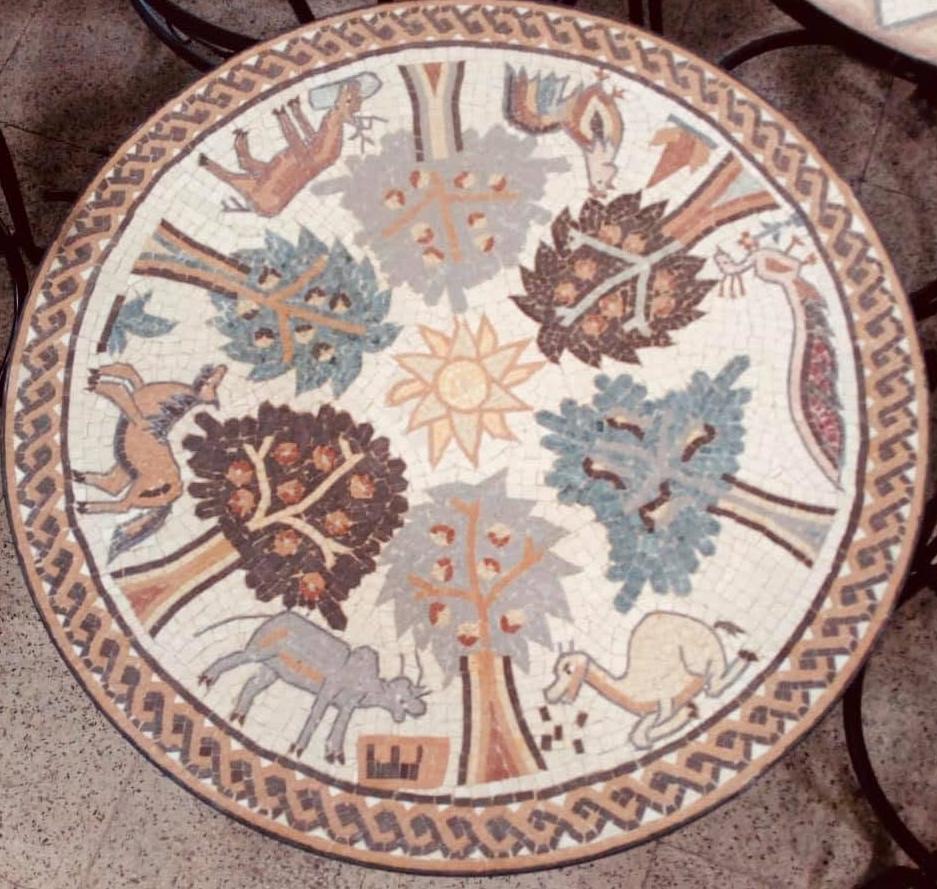 Round tabletop mosaic medallion with animals and trees